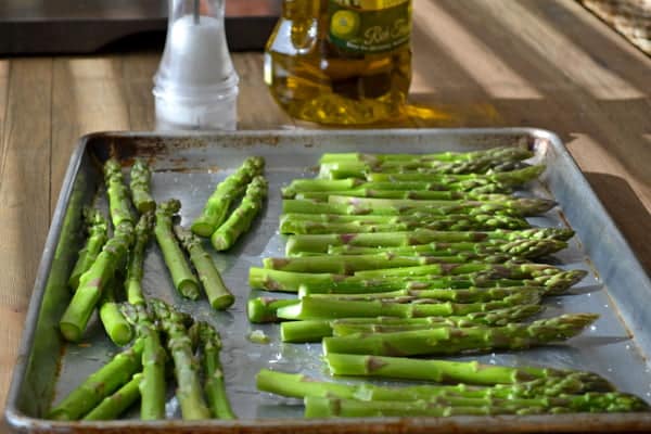 Asparagus getting ready for the oven where they will be roasted and then turned into a delicious but easy appetizer with parmesan cheese