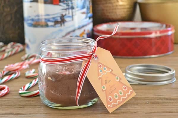 Candy Cane Hot Chocolate mix in a small glass jar with a gift tag.