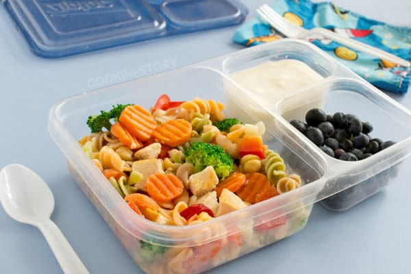 Make ahead pasta salad in lunch container with blueberries and yogurt in smaller sections.