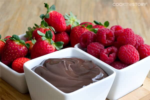 Dark Chocolate Greek Yogurt Fruit Dip in square white container with containers of fresh berries.