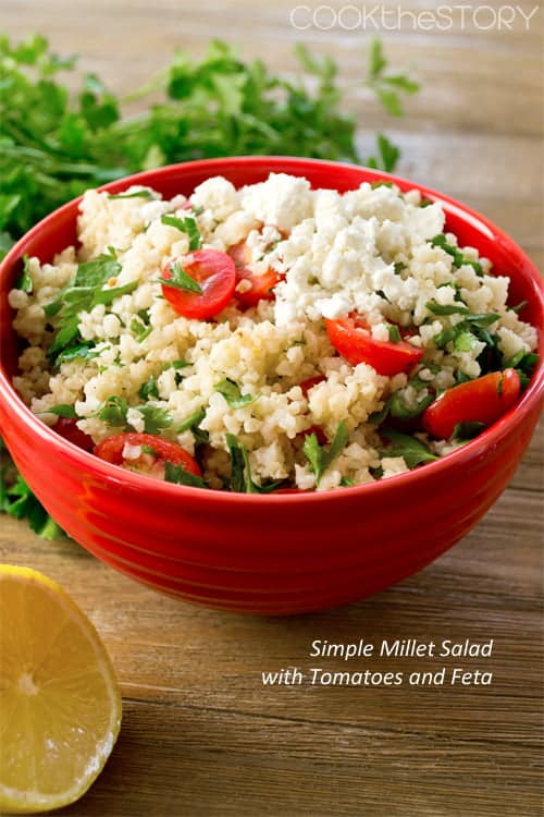 Millet Salad with Tomatoes and Feta in a red bowl. Text reads Simple Millet Salad with Tomatoes and Feta.