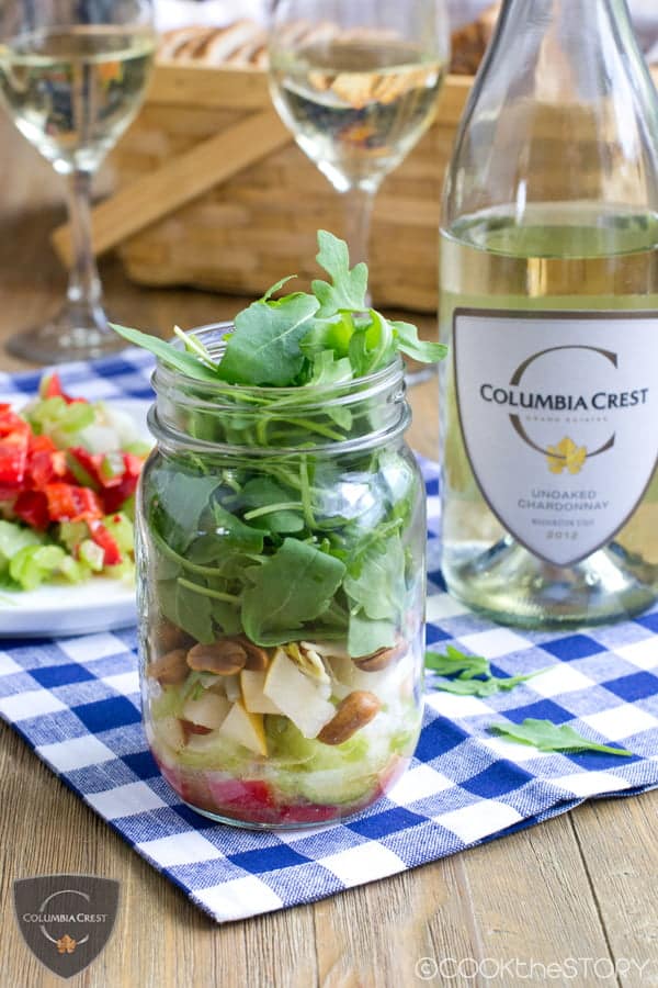 Asian Salad In A Jar next to a Chardonnay bottle on a white and blue checkered cloth.