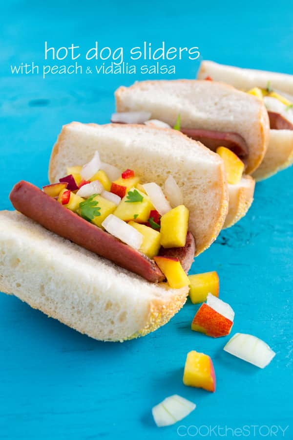 Hot Dog Sliders Topped with Peach and Vidalia Salsa on a blue table.