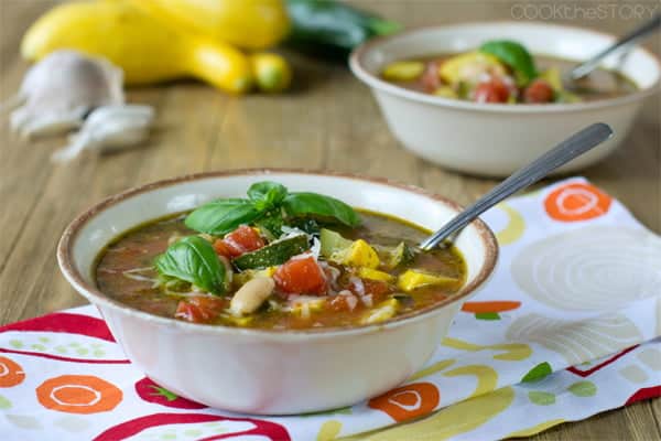 Summer Minestrone Soup topped with fresh basil leaves.