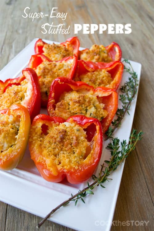 Halved bell peppers stuffed with chicken and cheese and topped with breadcrumbs.