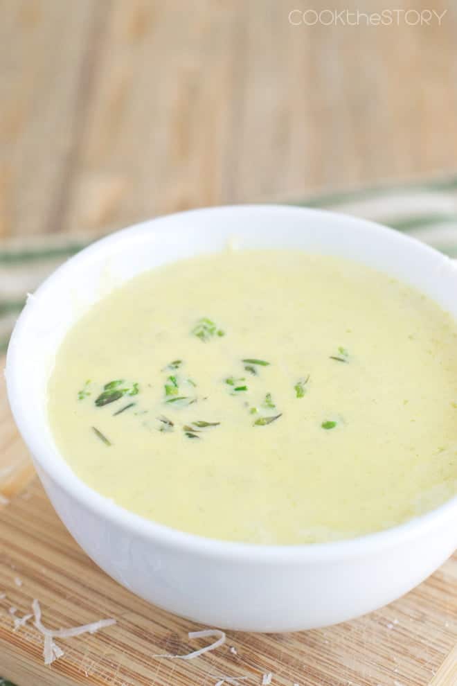 Creamy Asparagus Soup with Garlic and Parmesan in a white bowl.
